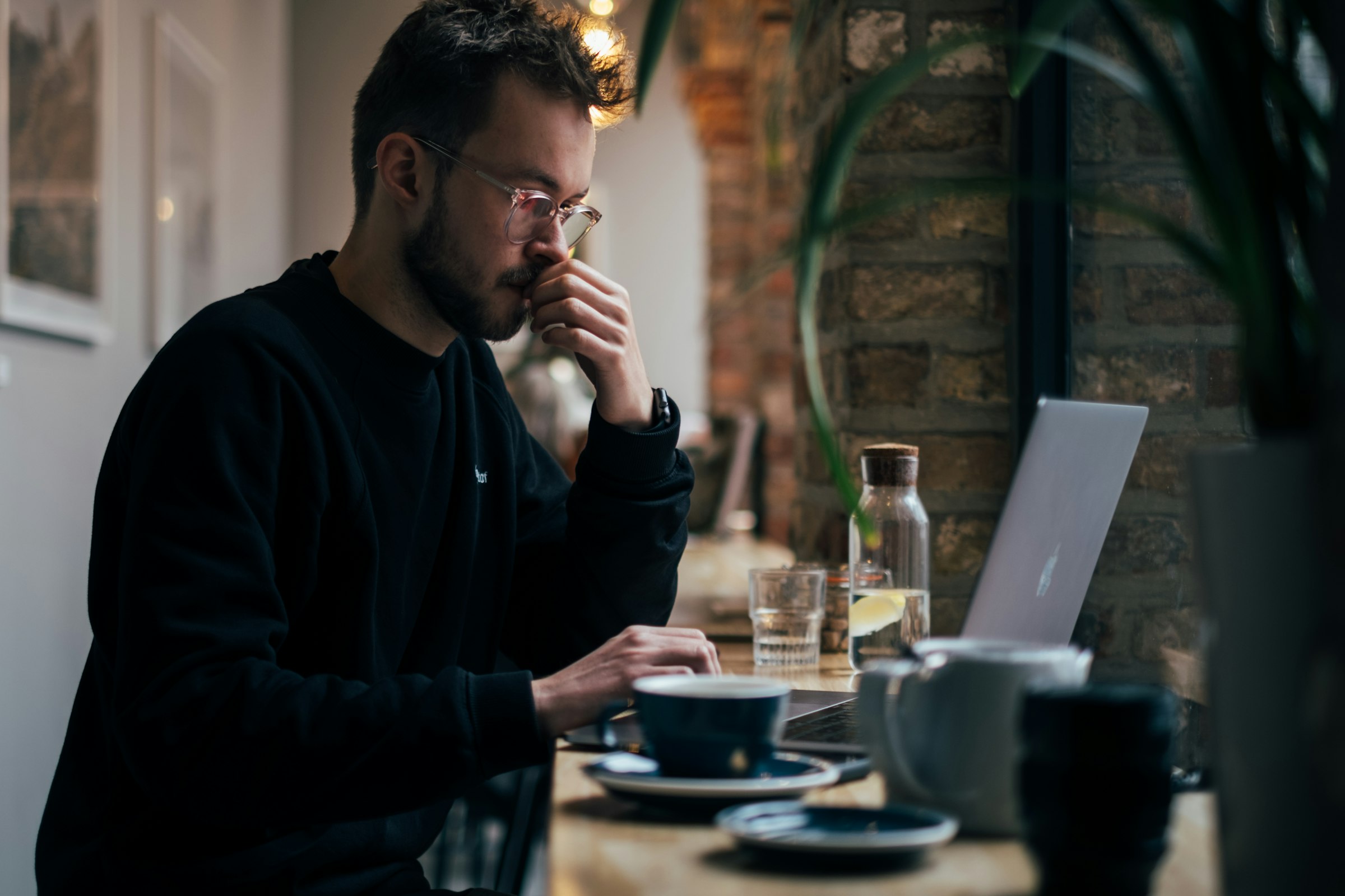 Person working on a laptop at a cafe table
